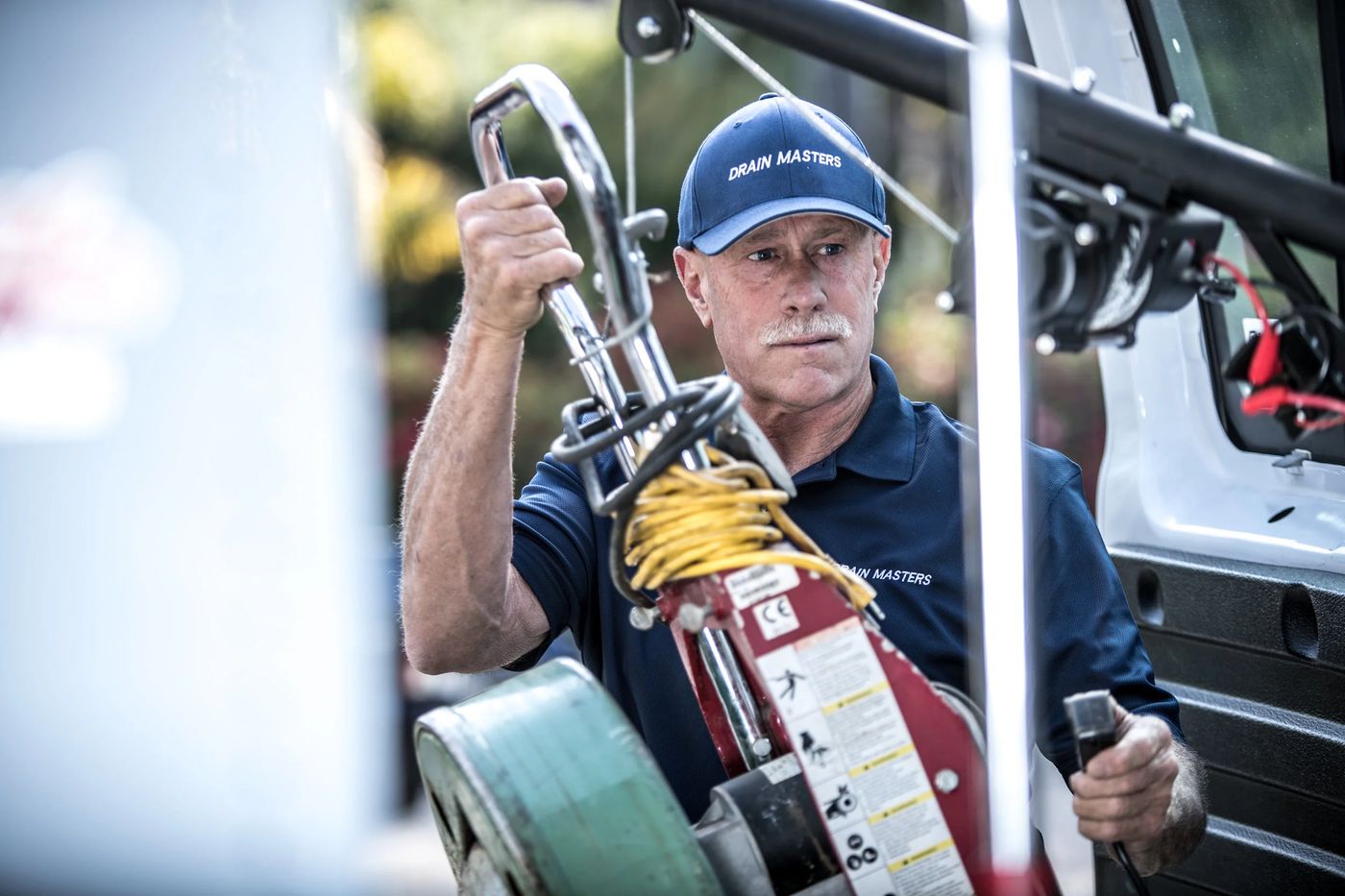 Drain Masters technician with service equipment